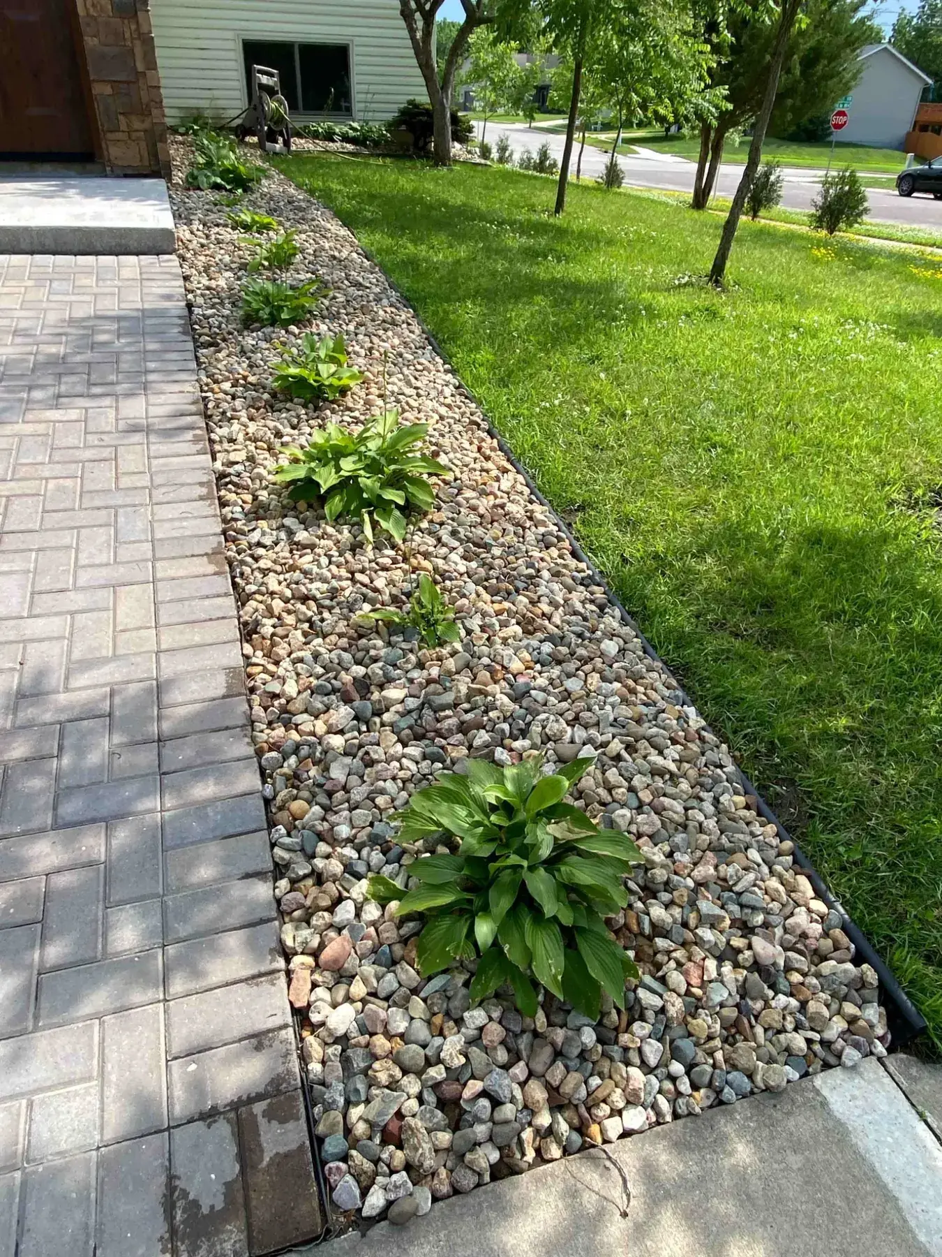 Finished stone walkway and rock landscaping project completed by Minnlawn